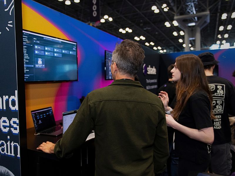 Image of an exhibitor showcasing a new product with an interested person at NAB Show New York.