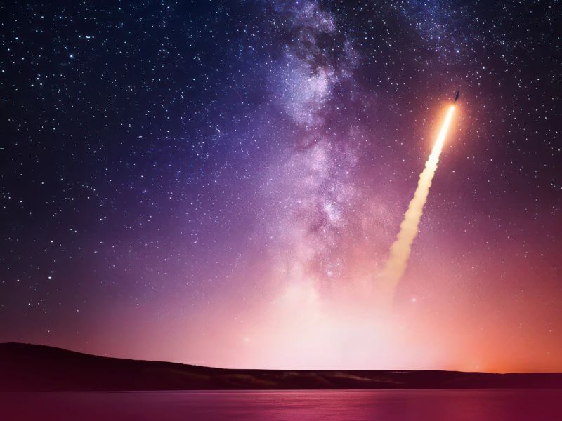 A graphic of a product launching into space with a night sky backdrop and open water in the foreground. 
