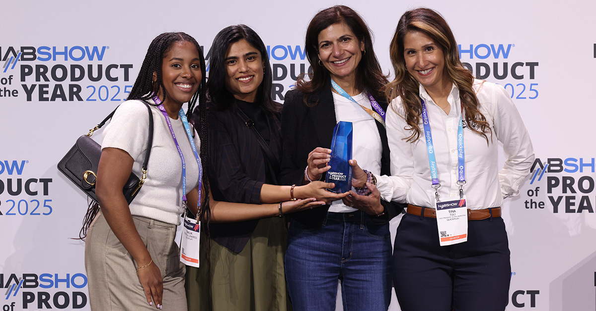 Four women gather on stage for a photo opportunity as they receive their 2025 product of the year award.