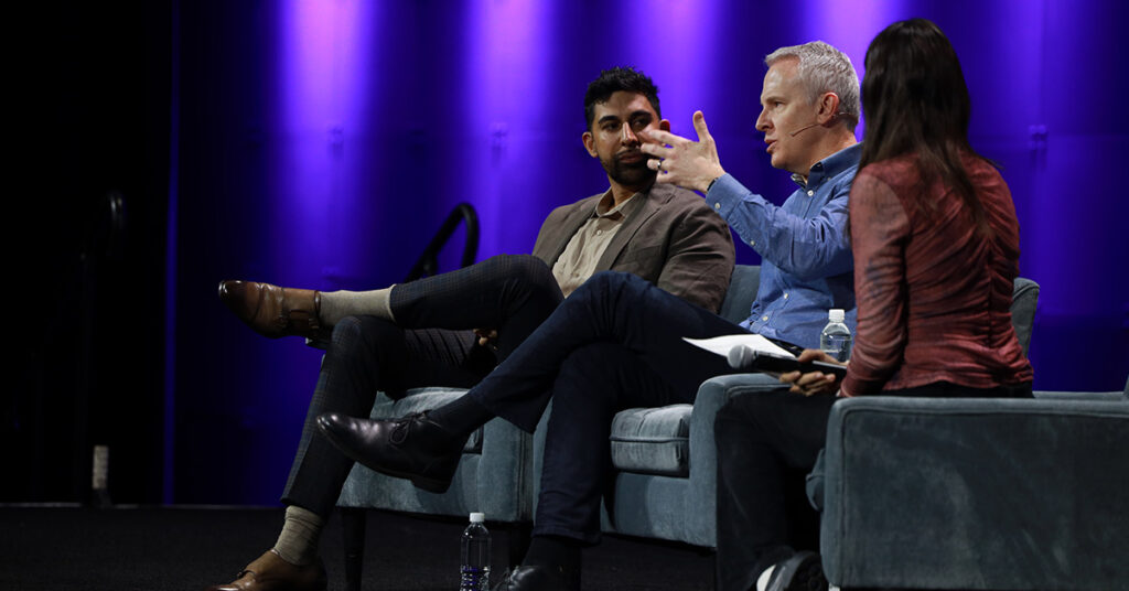 Three speakers sit side by side on stage at the 2025 NAB Show.