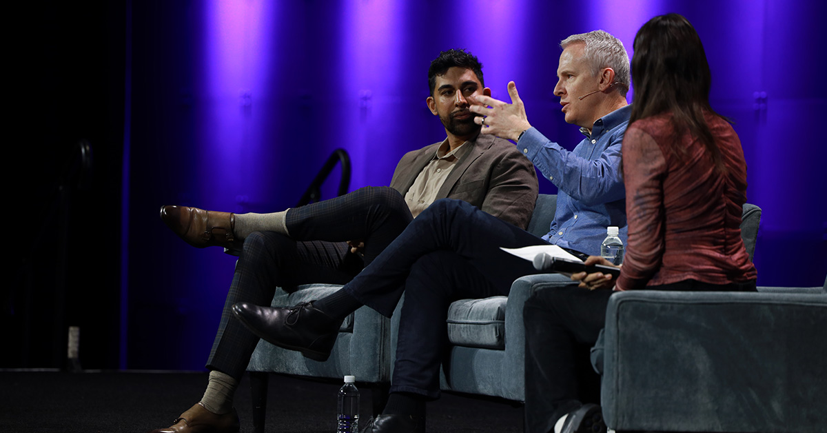 Three speakers sit side by side on stage at the 2025 NAB Show. 