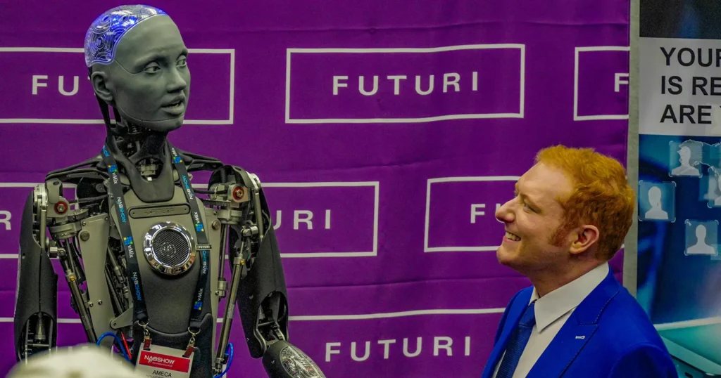 An image of a robot and a man smiling.