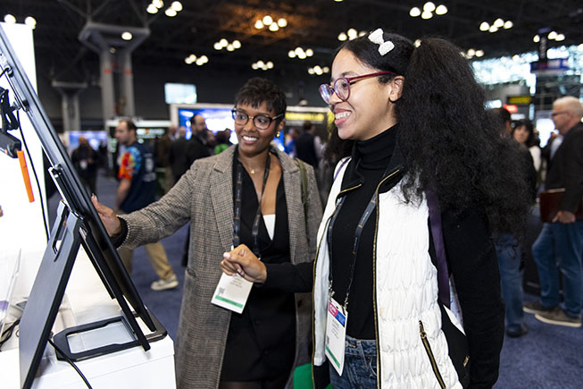 NAB Show New York attendees interacting with show floor exhibits