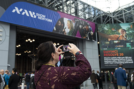 NAB Show New York attendee taking photo of exterior signage
